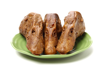 Duck head with marinated sauce on white background