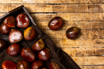 Fresh chestnuts on a wooden table
