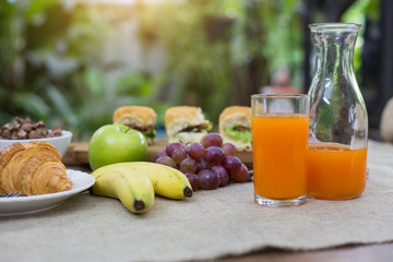 Breakfast including, bread,milk,honey, orange juice, muesli and fruits
