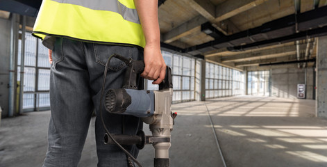 Fototapeta premium Construction Worker in front of construction site