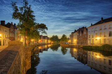 Obraz premium Noctilucent clouds (night shining clouds) at city Bruges (Brugge) old town in Belgium in the dusk, Europe