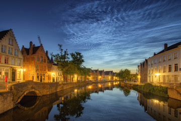 Noctilucent clouds (night shining clouds) at city Bruges (Brugge) old town in Belgium in the dusk, Europe