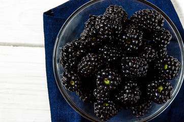 Large juicy black blackberry berries close-up with copy space
