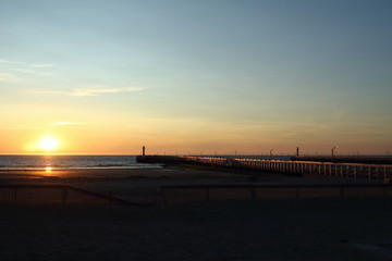 Nieuwpoort in Belgium. Pier and harbor entrance at sunset.