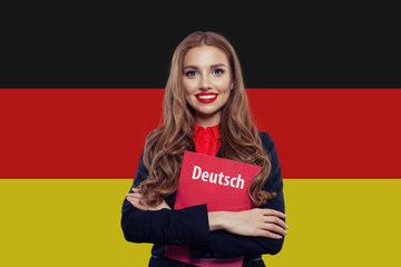 Portrait of happy young woman smiling against the Germany flag b