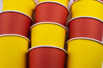 Red and yellow paper cups on the table.