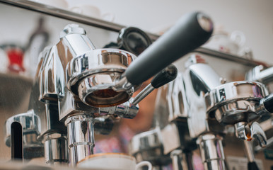 Coffee machine pouring coffee into white coffee cup.