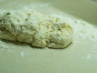 fresh dough on a kitchen wooden table