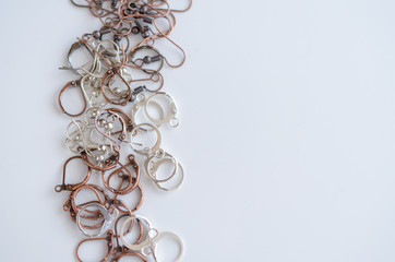 Assorted jewelry making supplies background with space for text.