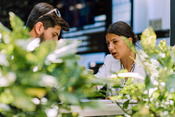 Young couple of professionals chatting during a coffee break