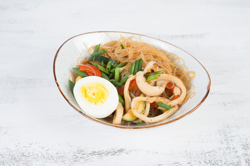 Traditional Asian stir fry with noodles, seafood and vegetables.
