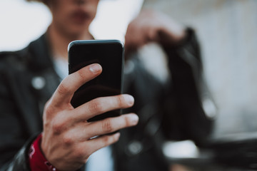 Modern smartphone in hand of young person