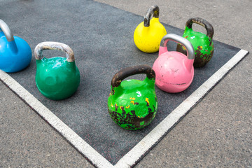 Colored kettlebells on the playground.