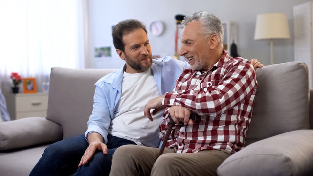 Cheerful adult males sharing memories father and son joking and having good time