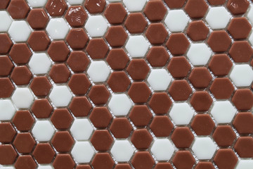 Texture of ceramic brown-white tiles in the form of a diamond