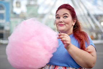 Fat young woman walking with cloud of candy-floss