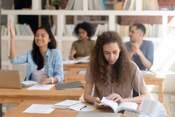 Diverse girls and guys students sitting in class during lecture