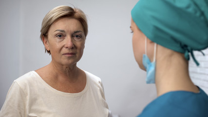 Crying woman looking at camera, received test results from doctor, bad diagnosis
