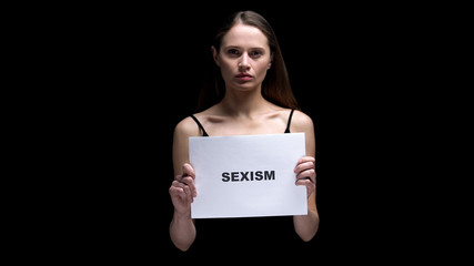 Woman showing sexism sign, protest against gender discrimination, human rights