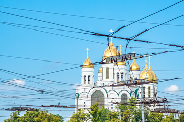 Wires of electric transport on the background of the Orthodox Church. Wires in the city are the enemies of the photographer.