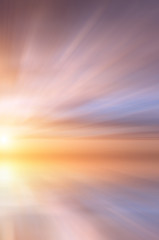 Abstract Bright sun at sunset on the background of small sea waves.