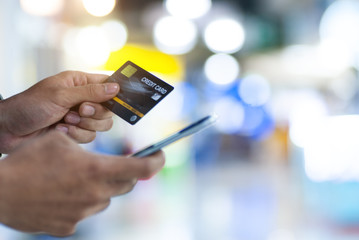  A man online payment,Man's hands holding a credit card and using smart phone for online shopping