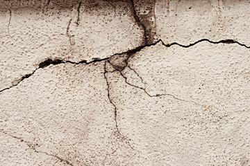 The texture of the plastered wall, the exterior of the building, the old wall cladding, cracked plaster