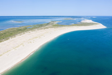 The cold waters of the Atlantic Ocean bathe a scenic beach on Cape Cod, Massachusetts. This...