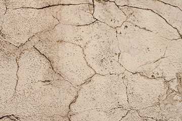 The texture of the plastered wall, the exterior of the building, the old wall cladding, cracked plaster