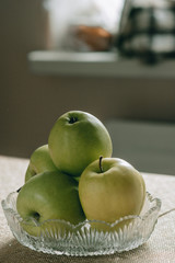Glass vase with green apples.Fresh juicy fruits, vegetarian food.