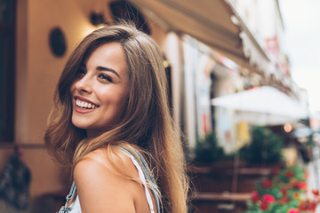 Image of pretty emotional happy girl sitting in cafe talking by mobile phone..