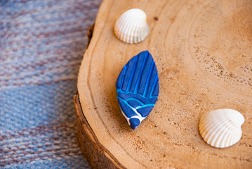 Art deco boho summer brooch of polymer clay. Fashion jewelry flat lay.