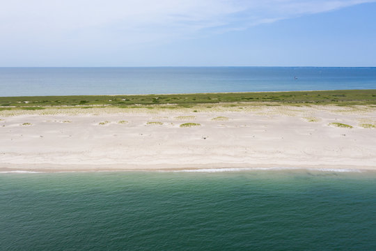 The cold waters of the Atlantic Ocean bathe a scenic beach on Cape Cod, Massachusetts. This beautiful area of New England, not too far from Boston, is a popular summer vacation destination.