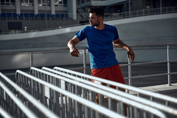 Sporty man resting after training on stadion