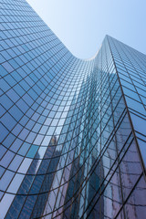 Blue glass skyscraper facade reflections against sky - 281941713