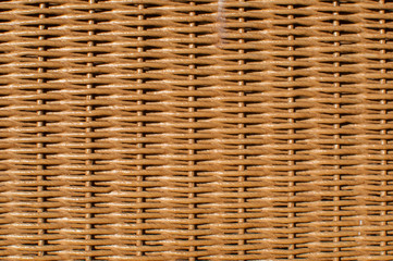Natural brown rattan woven furniture surface closeup as background