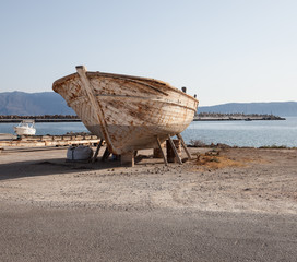 Fototapeta na wymiar Large old rusty boat on a beach