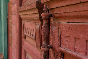 The old vintage wood handle on the old door