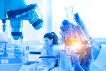 Double Exposure, hand holding flask, microscope, in medical research at laboratory, patient with health problems. Healthcare, pharmaceutical and medical concept.