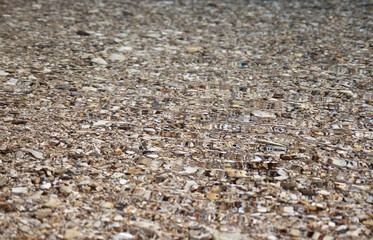 Clear crystal clear water on the beach with light pebbles