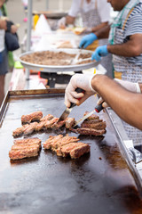 Man prepares traditional Turkish Kofte make in street food