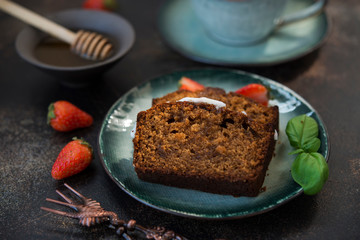 Two pieces of delicious honey cake with a Cup of coffee on a dark concrete background. Horizontal orientation