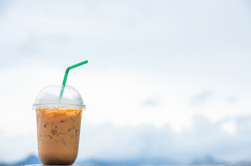 Glass of cold espresso coffee Background blurry views sky.