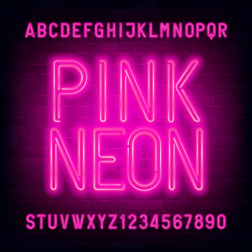 Pink Neon alphabet font. Light bulb letters and numbers on brick wall background. Stock vector typescript for your typography design.