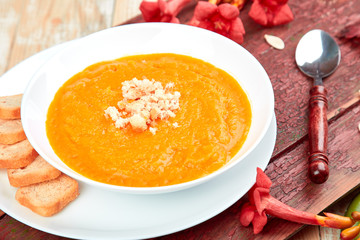 Cream of pumpkin soup on a white wooden background.  Diet vegetarian pupmkin soup puree. Rustic. Thanksgiving Day.