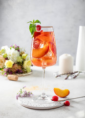 glass of wine with peaches ice and mint