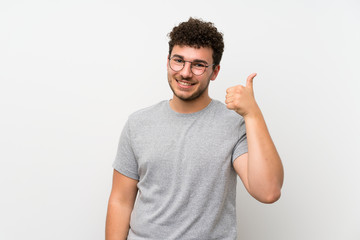 Naklejka premium Man with curly hair over isolated wall with glasses
