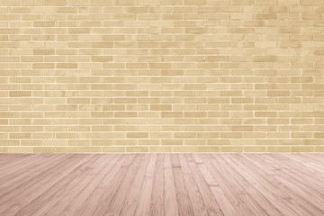 Light yellow brown brick wall with wooden floor in red brown