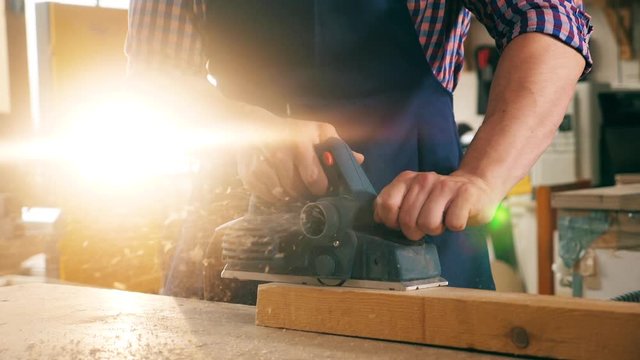 Jigsaw is processing a wooden block in slow motion