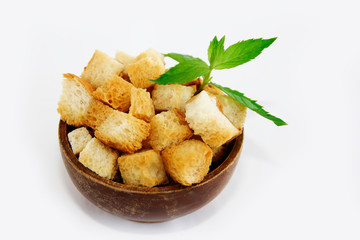 fried white bread croutons with mint leaves in wooden plate